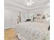 Bright main bedroom boasts en suite bathroom, white wood bed frame, and neutral decor at 9330 Se 106Th Pl, Belleview, FL 34420