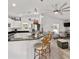 Open-concept space featuring a kitchen with bar seating flowing into the living area at 9330 Se 106Th Pl, Belleview, FL 34420