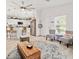 Open-concept space featuring a kitchen with bar seating flowing into the living area with stylish chairs at 9330 Se 106Th Pl, Belleview, FL 34420