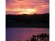 Scenic view of the lake and pier during a sunset with vibrant colors in the sky at 9330 Se 106Th Pl, Belleview, FL 34420