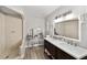 Bright bathroom featuring a double vanity with stylish faucets and a tiled walk-in shower at 11 Se Fir Trail Trak, Ocala, FL 34472