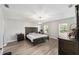 Spacious bedroom boasts wood floors, a dark wood bedroom set, and lots of natural light at 11 Se Fir Trail Trak, Ocala, FL 34472