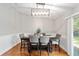 A modern dining area featuring a dark wood table, six chairs, and a stylish light fixture at 11 Se Fir Trail Trak, Ocala, FL 34472