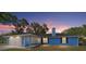 Exterior view of a charming blue home featuring a well-maintained lawn at 11 Se Fir Trail Trak, Ocala, FL 34472