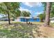 Charming blue home featuring a well-manicured lawn and mature trees at 11 Se Fir Trail Trak, Ocala, FL 34472