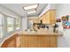 Bright eat-in kitchen with wood cabinets, stainless steel appliances, and lots of natural light at 11 Se Fir Trail Trak, Ocala, FL 34472