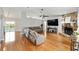 Inviting living room with hardwood floors, stone fireplace, and ample seating at 11 Se Fir Trail Trak, Ocala, FL 34472