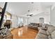 Bright living room featuring hardwood floors, stone fireplace, and comfortable seating arrangement at 11 Se Fir Trail Trak, Ocala, FL 34472