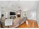 Spacious living room showcasing a stone fireplace, hardwood floors, and a comfortable seating area at 11 Se Fir Trail Trak, Ocala, FL 34472