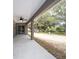 Covered back porch with ceiling fan, overlooking the private backyard at 1143 Sw Tamiami Pl, Dunnellon, FL 34431
