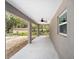 Covered back porch with ceiling fan, perfect for outdoor entertaining and relaxing at 1143 Sw Tamiami Pl, Dunnellon, FL 34431