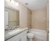 Bright bathroom features a bathtub with tile surround and a vanity with granite countertop at 1143 Sw Tamiami Pl, Dunnellon, FL 34431