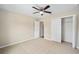 Bedroom with carpet flooring, ceiling fan, and a closet door at 1143 Sw Tamiami Pl, Dunnellon, FL 34431