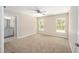 This bedroom features neutral paint, carpeted flooring, and two windows for ample natural light at 1143 Sw Tamiami Pl, Dunnellon, FL 34431