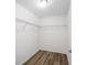 Walk in closet with shelving and wood-look flooring, offering ample storage at 1143 Sw Tamiami Pl, Dunnellon, FL 34431