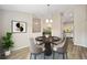 Cozy dining area featuring a round wood table, seating for four, and stylish decor at 1143 Sw Tamiami Pl, Dunnellon, FL 34431