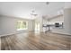 Expansive open-concept living area with kitchen access and ample natural light and high ceilings at 1143 Sw Tamiami Pl, Dunnellon, FL 34431