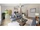 Bright, open-concept living room with modern furnishings, and access to kitchen and dining area at 1143 Sw Tamiami Pl, Dunnellon, FL 34431