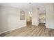 Open-concept living area with durable floors, neutral paint, and pendant lighting at 1143 Sw Tamiami Pl, Dunnellon, FL 34431