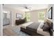 This main bedroom features a ceiling fan, ensuite bathroom, and decorative touches at 1143 Sw Tamiami Pl, Dunnellon, FL 34431