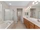 Spacious bathroom features double sink vanity, soaking tub, and glass-enclosed shower at 12804 Se 90Th Court Rd, Summerfield, FL 34491