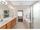Bathroom view features double sink vanity, soaking tub, and glass shower stall at 12804 Se 90Th Court Rd, Summerfield, FL 34491