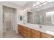 Bright bathroom features double vanity sink, glass-enclosed shower, and walk-in closet at 12804 Se 90Th Court Rd, Summerfield, FL 34491