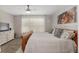 Bright bedroom features modern ceiling fan, natural light, and wood-look flooring at 12804 Se 90Th Court Rd, Summerfield, FL 34491