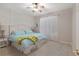 Bright bedroom features neutral paint colors, modern ceiling fan, and white trim at 12804 Se 90Th Court Rd, Summerfield, FL 34491