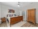 Cozy bedroom boasts natural light, wood flooring, and ensuite bathroom access at 12804 Se 90Th Court Rd, Summerfield, FL 34491