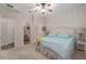 Comfortable bedroom with adjoining bathroom access and neutral paint colors at 12804 Se 90Th Court Rd, Summerfield, FL 34491