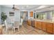 Dining area featuring a glass table, seating for four, and convenient access to kitchen and backyard at 12804 Se 90Th Court Rd, Summerfield, FL 34491