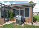 Outdoor grill on a concrete patio near the lanai providing a delightful space for barbecues and outdoor dining at 12804 Se 90Th Court Rd, Summerfield, FL 34491