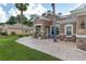 Charming single-story home with a well-manicured lawn, stone accents, and a beautiful walkway at 12804 Se 90Th Court Rd, Summerfield, FL 34491