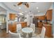 Bright eat-in kitchen features wood cabinets, stainless steel appliances, and breakfast table at 12804 Se 90Th Court Rd, Summerfield, FL 34491