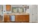 Eat-in kitchen with backyard views, a stainless steel dishwasher, and ample counter space at 12804 Se 90Th Court Rd, Summerfield, FL 34491