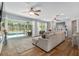 Open-concept living room with seamless access to the outdoor pool area, maximizing natural light at 12804 Se 90Th Court Rd, Summerfield, FL 34491