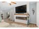 Living room with a modern fireplace and mounted television, creating a cozy and stylish space at 12804 Se 90Th Court Rd, Summerfield, FL 34491