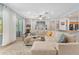 Bright living room featuring a large sectional sofa, neutral paint, and sliding glass doors to the outside at 12804 Se 90Th Court Rd, Summerfield, FL 34491