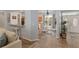 Open concept living space with wood-look tile flooring and a view of the dining area and foyer at 12804 Se 90Th Court Rd, Summerfield, FL 34491
