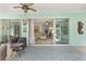 Open screened patio offering seamless indoor-outdoor living with multiple seating arrangements at 12804 Se 90Th Court Rd, Summerfield, FL 34491