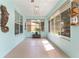 Bright, airy sunroom with multiple windows, a wooden seahorse decoration, and blue walls that bring the outdoors in at 12804 Se 90Th Court Rd, Summerfield, FL 34491