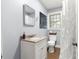 Bathroom featuring a modern vanity, neutral color palette, and shower behind decorative curtain at 1405 Ne 55Th St, Ocala, FL 34479
