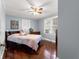 Cozy bedroom with hardwood floors, ample natural light from the windows, and a comfortable queen-sized bed at 1405 Ne 55Th St, Ocala, FL 34479