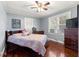 Cozy bedroom with hardwood floors, ample natural light from the windows, and a comfortable queen-sized bed at 1405 Ne 55Th St, Ocala, FL 34479