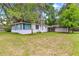 Charming home with a well-maintained lawn and detached garage at 1405 Ne 55Th St, Ocala, FL 34479