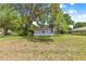 Charming home featuring a quaint screened porch and a spacious, tree-shaded front yard at 1405 Ne 55Th St, Ocala, FL 34479