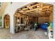View of the garage with motorcycle parked among wood and various items at 1405 Ne 55Th St, Ocala, FL 34479