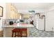 Kitchenette with marble counters and seating, seamlessly integrated into the dining area at 1405 Ne 55Th St, Ocala, FL 34479