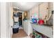 View of the laundry room featuring a washer and dryer, wash basin and ample storage at 1405 Ne 55Th St, Ocala, FL 34479